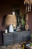 ABIGAIL AHERN HOUSE, LONDON: BEDROOM PAINTED IN CROSBY - DARK, ROOM, INTERIOR, DAWLISH SIDEBOARD WITH STONE FACADE. SHAGGY PALM LAMP, MIRROR