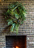 ABIGAIL AHERN HOUSE, LONDON: THE DINING ROOM - DARK, INTERIOR, WALL, DECORATION, GREEN WREATH, WALL, FIREPLACE