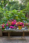 HENRIETTA COURTAULDS HOUSE, NOTTING HILL, LONDON: THE LAND GARDENERS - SMALL TOWN GARDEN. PATIO, TERRACE, TABLE WITH CUT DAHLIA FLOWERS. GREEN, CONTAINERS