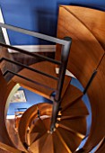 MORTON HALL, WORCESTERSHIRE: DETAIL OF SPIRAL STAIRCASE IN BRUSHED STEEL AND SMOKED OAK, DESIGNED BY CARL GEORG LUETCKE. LOOKING DOWN FROM BEDROOM INTO STUDY