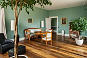 MORTON HALL, WORCESTERSHIRE: GARDEN ROOM PAINTED IN FB DIX BLUE. OVAL TABLE CA. 1820, CHERRY WOOD, SOUTHERN GERMAN.ARMCHAIRS IN WALNUT, CA. 1825 SOUTH WEST GERMAN. WOODEN FLOOR.