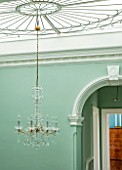 MORTON HALL, WORCESTERSHIRE:MINT GREEN PAINTED STAIRWELL WITH ART NOUVEAU SKYLIGHT & CHANDELIER IN BOHEMIAN CRYSTAL. AREA CONNECTS TWO PARTS OF HOUSE-CENTRAL & VICTORIAN WING