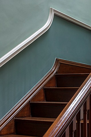 MORTON_HALL_WORCESTERSHIRE_DETAIL_OF_WOODEN_STAIRCASE_IN_HALLWAY_PAINTED_FB_GREENBLUE_ABOVE_DADO_AND
