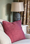 THE COACH HOUSE,SURREY: THE GARDEN ROOM WITH DETAIL OF SOFA, CLARET CUSHION AND LAMP BY OKA