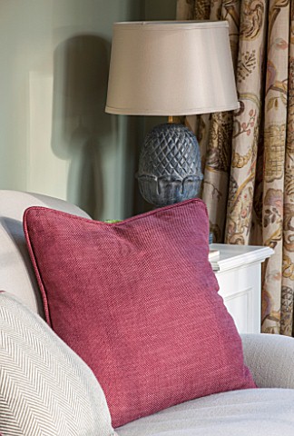 THE_COACH_HOUSESURREY_THE_GARDEN_ROOM_WITH_DETAIL_OF_SOFA_CLARET_CUSHION_AND_LAMP_BY_OKA