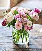 THE COACH HOUSE, SURREY: DETAIL OF FRESH RANUNCULUS, ROSES AND TULIPS IN VASE ON COFFEE TABLE. PRETTY, DECORATIVE, DISPLAY, ARRANGEMENT.