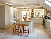 THE COACH HOUSE,SURREY:COUNTRY KITCHEN BY PLAIN ENGLISH, STOOLS FROM POTTERY BARN AND ISLAND.NEUTRAL DECOR,LIGHT,AIRY, TUMBLED MARBLE FLOOR, BELFAST/BUTLER SINK