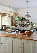 THE COACH HOUSE,SURREY: COUNTRY KITCHEN BY PLAIN ENGLISH, NEUTRAL DECOR. ISLAND WITH BRUSHED STEEL PENDANT LIGHTS, POTS AND PANS HANGING ABOVE AGA WITH SHELF