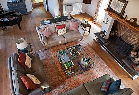 THE_COACH_HOUSESURREY_OVERVIEW_OF_FAMILY_ROOM_WITH_SOFAS_LARGE_GLASS_COFFEE_TABLE_BEAUTIFUL_RUG_ON_W