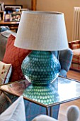 THE COACH HOUSE,SURREY: FAMILY ROOM WITH DETAIL OF LAMP BY OKA OIN GLASS SIDE TABLE BY JULIAN CHICHESTER