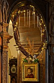 BURTON AGNES HALL, EAST YORKSHIRE: CHRISTMAS  - GREAT HALL - DRIED VINE WREATH DECORATED WITH GOLDEN FERNS AND FAIRY LIGHTS, MADE BY THE GARDENERS. ORNAMENT