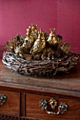 BURTON AGNES HALL, EAST YORKSHIRE: CHRISTMAS - THE DINING ROOM WITH HAND MADE NEST WREATH FILLED WITH DRIED SPRAYED THISTLE, ERYNGIUM SEED HEADS AND GOLD BIRD DECORATIONS
