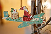 BURTON AGNES HALL, EAST YORKSHIRE: CHRISTMAS - THE GARDEN GALLERY - WOODEN AEROPLANE CUT OUT DECORATION IN OAK TREE. ORNAMENT, DECORATION