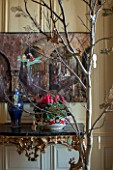 BURTON AGNES HALL, EAST YORKSHIRE: CHRISTMAS - GARDEN GALLERY - WOODEN AEROPLANE AND SLEIGH CUT OUT DECORATIONS IN OAK BRANCH TREE, CERAMIC BOWL PLANTED WITH CYCLAMEN