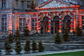 VAUX LE VICOMTE, FRANCE: THE ENTRANCE TO THE PALACE AT CHRISTMAS DECORATED WITH RIBBON BOWS AND CHRISTMAS TREES. TREE, LIGHT, LIGHTING, ILLUMINATION, WINTER
