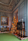VAUX LE VICOMTE, FRANCE: THE KINGS FORMER STUDY AT CHRISTMAS. GREY PANELLED WALLS AND CHRISTMAS TREE.