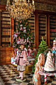 VAUX LE VICOMTE, FRANCE: THE KINGS ANTICHAMBER - LOUIS XIV MAHOGANY BOOKSHELVES. SWEET AND SUGAR DECORATIONS REPRESENT THE GERMAN FAIRTY TALE HANSEL AND GRETEL
