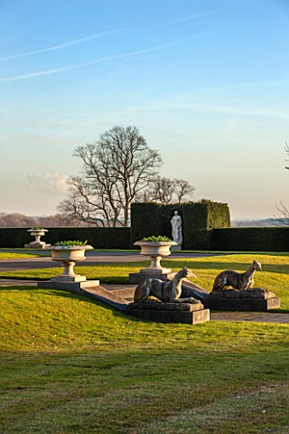 BRODSWORTH_HALL_YORKSHIRE_DAWN_WINTER_JANUARY_VIEW_ACROSS_LAWN_TO_YEW_HEDGE_STATUES_URNS_STONE_ORNAM