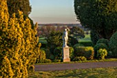 BRODSWORTH HALL, YORKSHIRE: VIEW ACROSS LAWN TO BORDER OF TOPIARY. VICTORIAN, COUNTRY, GARDEN, FORMAL, STATUARY, STATUES, STATUE, CLIPPED, COUNTRYSIDE, EVENING