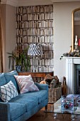 THE FREETH, HEREFORDSHIRE: THE SITTING ROOM. FIRE, FIREPLACE, BOOKCASE WALL PAPER, TEAL SOFAS, WOOD FLOOR, GLASS AND STONE PEDESTAL TABLE, GILT MIRROR, LIVING, ROOM