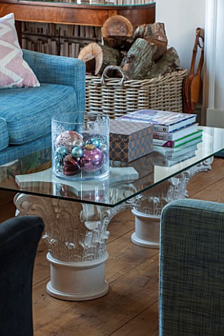 THE_FREETH_HEREFORDSHIRE_THE_SITTING_ROOM_GLASS_AND_STONE_PEDESTAL_COFFEE_TABLE_TEAL_SOFA_LOG_BASKET