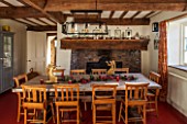 THE FREETH, HEREFORDSHIRE: KITCHEN, DINER - WOODEN FARMHOUSE TABLE, SCHOOL, CHURCH CHAIRS, GOLDEN ANTIQUE ANGEL CANDLE HOLDERS, FIREPLACE, RED FLOORING
