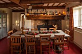 THE FREETH, HEREFORDSHIRE: KITCHEN, DINER - WOODEN FARMHOUSE TABLE, SCHOOL, CHURCH CHAIRS, GOLDEN ANTIQUE ANGEL CANDLE HOLDERS, FIREPLACE, RED FLOORING