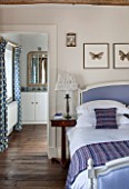 THE FREETH, HEREFORDSHIRE: LILAC BEDROOM - BED, CUSHIONS, BUTTERFLY PRINTS, THROW, PRESENTS, CHRISTMAS, EN SUITE BATHROOM, BEDSIDE LAMP, WOODEN FLOOR