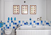 THE FREETH, HEREFORDSHIRE: TURQUOISE AND WHITE BATHROOM. BATH, TILES, TOILET, PRINTS