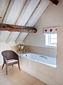 THE FREETH, HEREFORDSHIRE: DOUBLE BEDROOM - BATHROOM, WHITE, TULIP PRINT BLIND, WICKER CHAIR, BATH