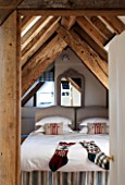 THE FREETH, HEREFORDSHIRE: BEDROOM WITH EVES, WOODEN BEAMS, STOCKINGS, CHRISTMAS, CUSHIONS, BED