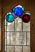 PAINSWICK ROCOCO GARDEN, GLOUCESTERSHIRE: STAINED GLASS IN A WINDOW IN THE RED HOUSE. GOTHIC, BUILDING, FOLLY, FOLLIES