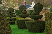 FELLEY PRIORY, NOTTINGHAMSHIRE: CLIPPED TOPIARY YEW PEACOCKS IN SPRING, FORMAL, COUNTRY, ENGLISH, GARDEN, GREEN