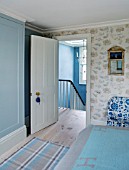 LONDON HOUSE DESIGNED BY JULIE SIMONSEN. DOOR SHOWING ENTRANCE TO BLUE BEDROOM WITH DASH & ALBERT CHECKED RUG.