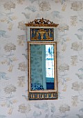 LONDON HOUSE DESIGNED BY JULIE SIMONSEN.  BLUE BEDROOM. GUSTAVIAN MIRROR IN GRECIAN STYLE BOUGHT FROM COUSIN. WALLPAPER BY COLEFAX & FOWLER