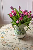 LONDON HOUSE DESIGNED BY JULIE SIMONSEN. TULIPS IN JUG ON PAINTED ANTIQUE TABLE FROM THE BALTICS