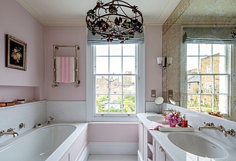 LONDON_HOUSE_DESIGNED_BY_JULIE_SIMONSEN_THE_PINK_BATHROOM_WITH_PANELLED_BATH_AND_DOUBLE_BASINS_WITH_