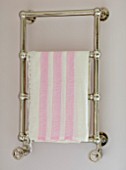 LONDON HOUSE DESIGNED BY JULIE SIMONSEN. PINK BATHROOM. CHROME TOWEL RAIL ON WALL WITH PINK AND WHITE STRIPED TOWEL