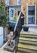 LONDON HOUSE DESIGNED BY JULIE SIMONSEN. STEPS FROM KITCHEN LEADING DOWN INTO GARDEN