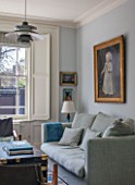 LONDON HOUSE DESIGNED BY JULIE SIMONSEN. LIVING ROOM WITH INHERITED DUTCH PAINTING THAT PROVIDED INSPIRATION FOR COLOUR SCHEME. SOFA BY CARAVANE AND VINTAGE STUDDED LEATHER TRUNK USED AS COFFEE TABLE.