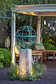 DAVID HARBER SUNDIALS:CHELSEA 2017.BRONZE ARMILLERY SPHERE SCULPTURE WITH WOODEN PAVILLION/PERGOLA AND SEATING AREA.RELAX,CONTEMPORARY,MODERN,NIGHT,EVENING,LIGHTING,RELAX,ART,CRAFT