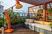 CHELSEA FLOWER SHOW 2017: CITY LIVING GARDEN DESIGNED BY KATE GOULD. MODERN, CONTEMPORARY, ANGLEPOISE LAMP, LIGHTING, ORANGE, SEAT, SEATING, DECK, DECKING, CUSHIONS, RELAXING