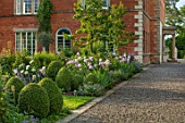 MORTON HALL, WORCESTERSHIRE: GRAVEL PATH, SOUTH GARDEN, CLIPPED YOPIARY BOX, LAWN, IRISES. SUMMER, SPRING, HERBACEOUS, BORDERS, PEONY, PEONIES