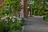 MORTON HALL, WORCESTERSHIRE: GRAVEL PATH, SOUTH GARDEN, CLIPPED YOPIARY BOX, LAWN, IRISES. SUMMER, SPRING, HERBACEOUS, BORDERS