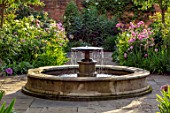 MORTON HALL, WORCESTERSHIRE: SOUTH GARDEN,  SUMMER. CIRCULAR FOUNTAIN, WALL, ROSE - ROSA OLD BLUSH CHINA. EVENING LIGHT, FORMAL, COUNTRY, GARDEN, ENGLISH, CLASSIC, WATER, FEATURE