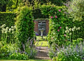 COTTAGE ROW, DORSET: ARCH WITH CLEMATIS MADAME JULIA CORREVON, SUNDIAL AND WALL. FRAMED, VIEW, CLIMBERS, CLIMBING