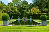 HAZELBY HOUSE, BERKSHIRE: SUMMER, YEW, HEDGES, HEDGING, POND, POOL, WATER, FORMAL, GARDEN, STATUE, REFLECTIONS, REFLECTED, WOODEN BENCH, SEAT
