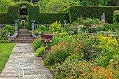 HAZELBY HOUSE, BERKSHIRE: LAWN, BORDERS, HEDGES, HEDGING, SUMMER, GARDEN, CONTAINERS, STATUE, ALCHEMILLA, GEUMS, ROSES, PATH, STAIRCASE, STEPS