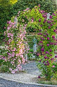 MOTTISFONT ABBEY, HAMPSHIRE: ARCH WITH ROSES - ROSA DEBUTANTE AND ROSA BLEU MAGENTA, SUMMER, ROSE, GARDEN, ARCHES, FORMAL, SUMMER, PINK, FLOWERS, FLOWERING, BLOOMS, BLOOMING