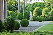MORTON HALL, WORCESTERSHIRE: GRAVEL TERRACE AT FRONT OF HALL WITH CLIPPED TOPIARY BOX BALLS. GREEN, STAUE, STAUES, STATUARY, FORMAL, COUNTRY, CLASSIC, GARDEN